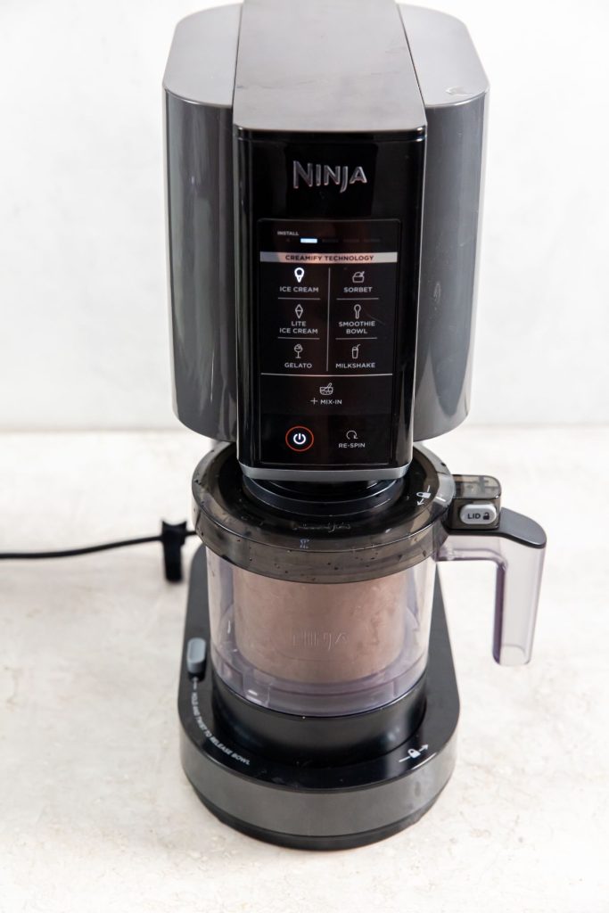 Ninja Creami Ice cream maker on a light surface.