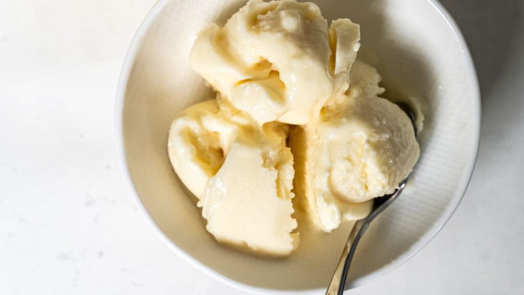 dole whip in a white bowl with a spoon.