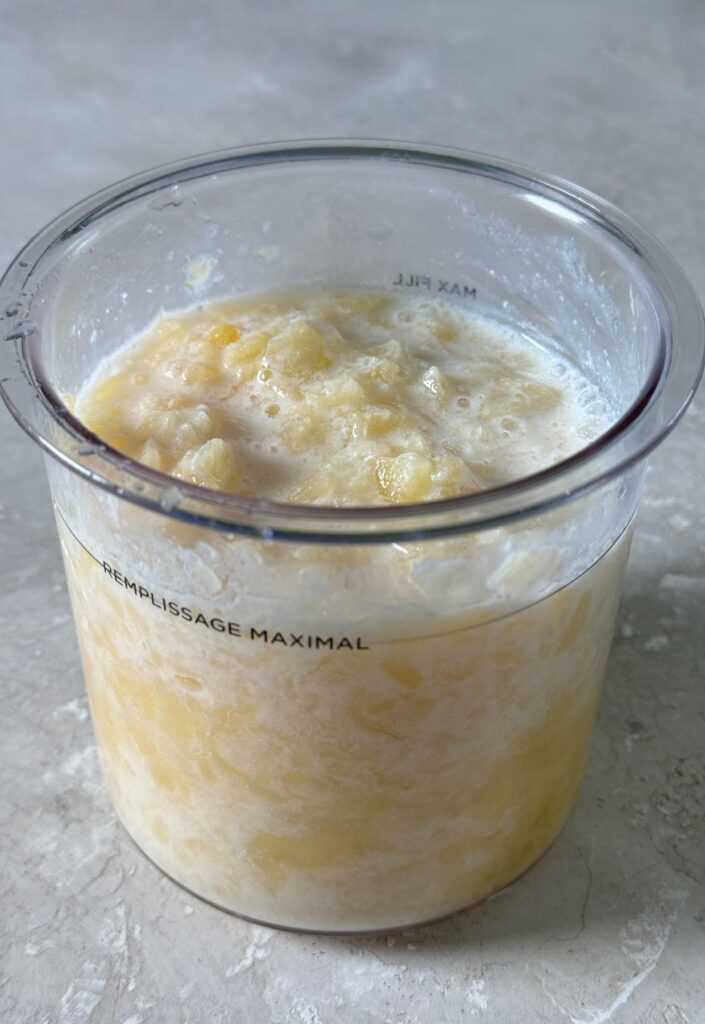 pineapple, milk and vanilla in a clear pint.