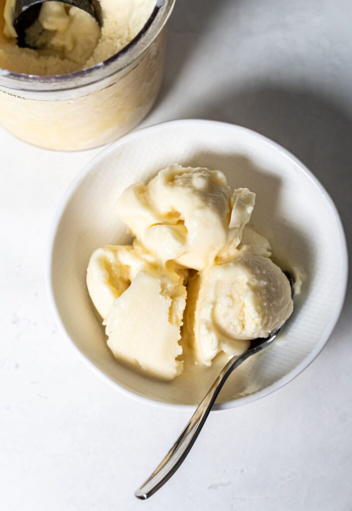 dole whip in a white bowl with a spoon.