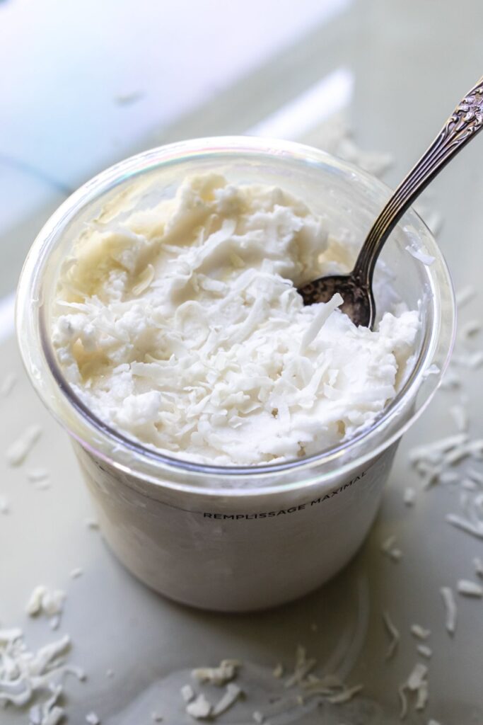 coconut ice cream in a pint with a spoon.