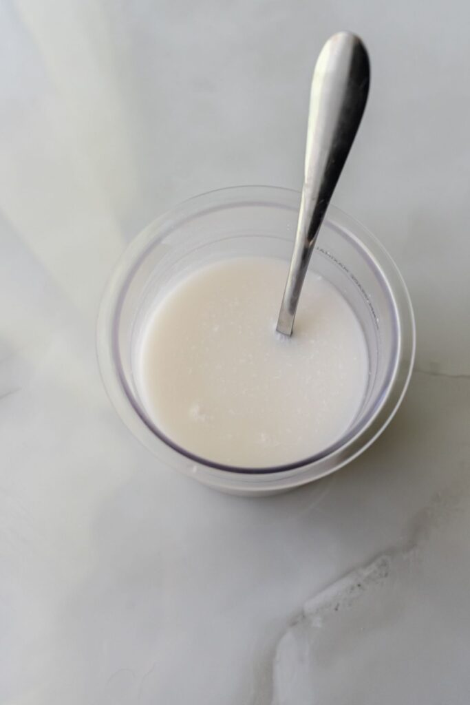 coconut milk with a spoon in a pint.