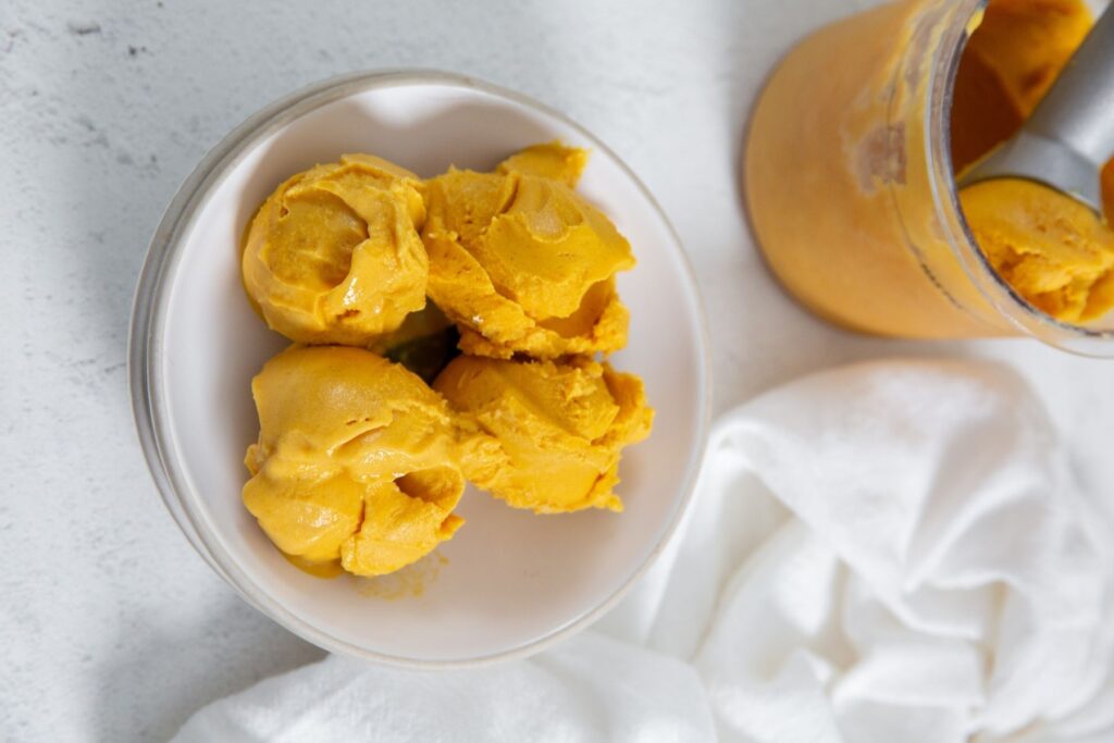 pumpkin ice cream in a white bowl.