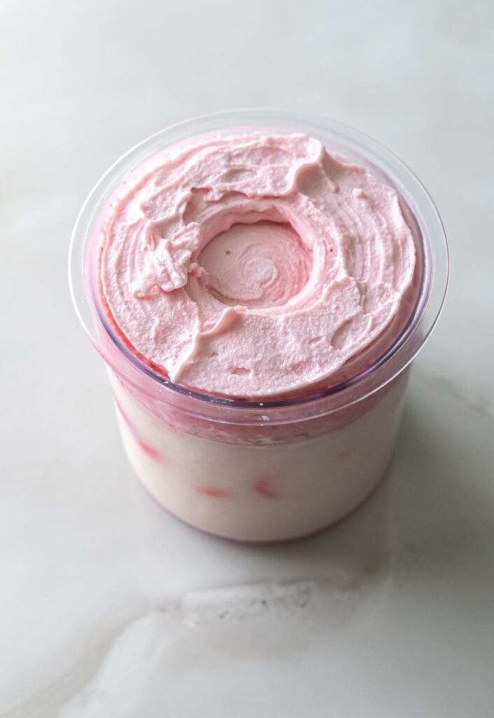 Ninja Creami strawberry ice cream in a pint container.