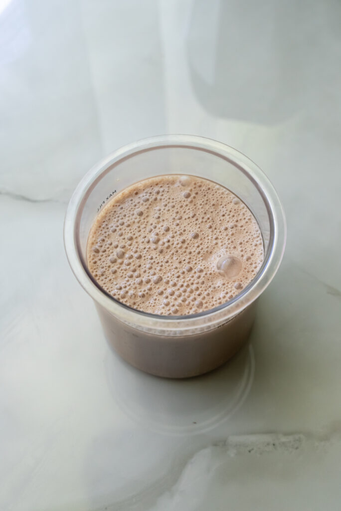 ninja creami pint with chocolate liquid.