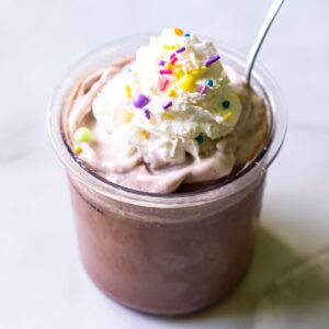 chocolate ice cream with whipped cream and sprinkles.