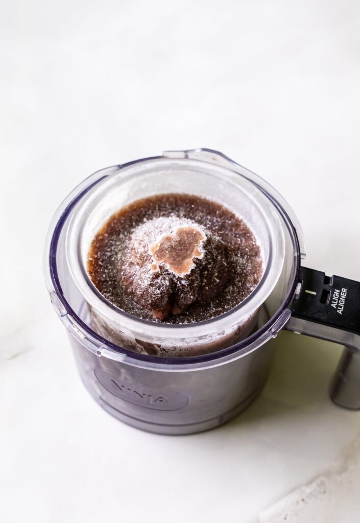 high protein chocolate ice cream in a clear pint.