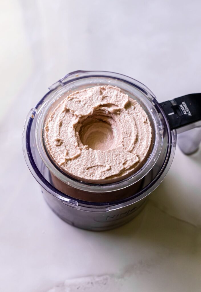 high protein chocolate ice cream in a clear pint.