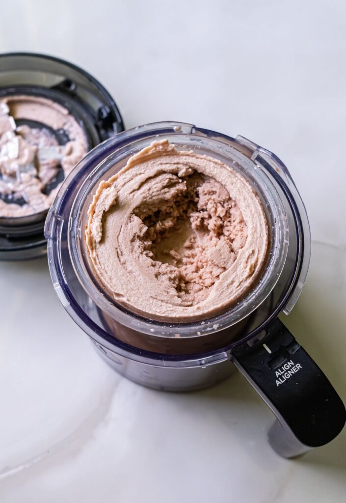 high protein chocolate ice cream in a clear pint.