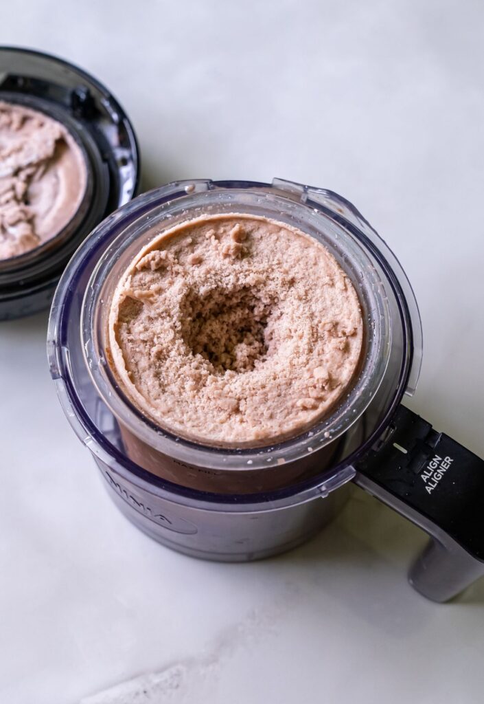 high protein chocolate ice cream in a clear pint.