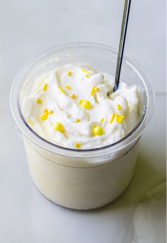 lemon protein ice ream with sprinkles and a spoon.