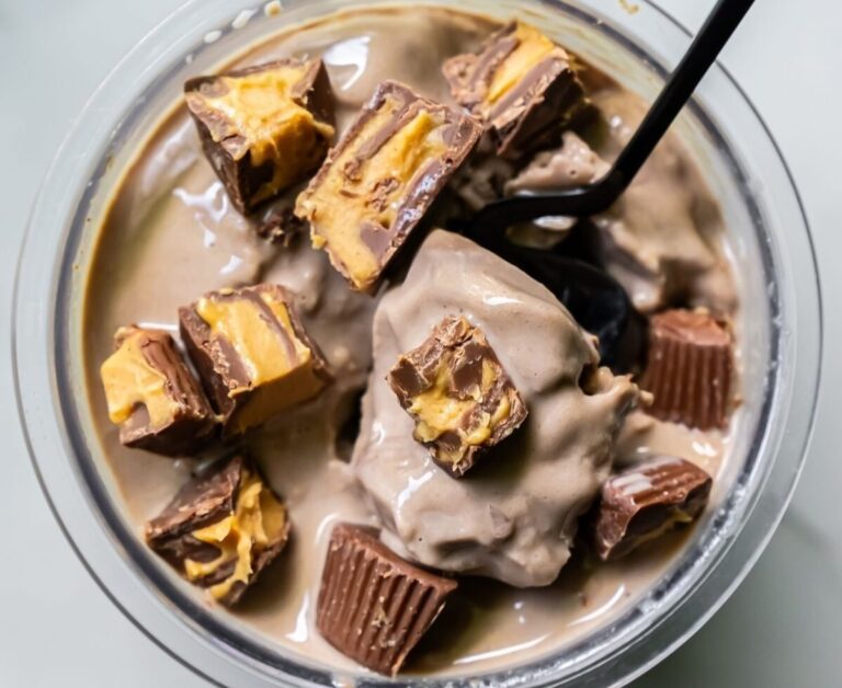 chocolate ice cream topped with PB cups with a spoon.