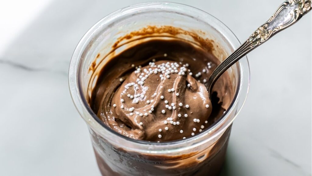 Dark Chocolate Protein Ice Cream with marshmallow, and spoon.