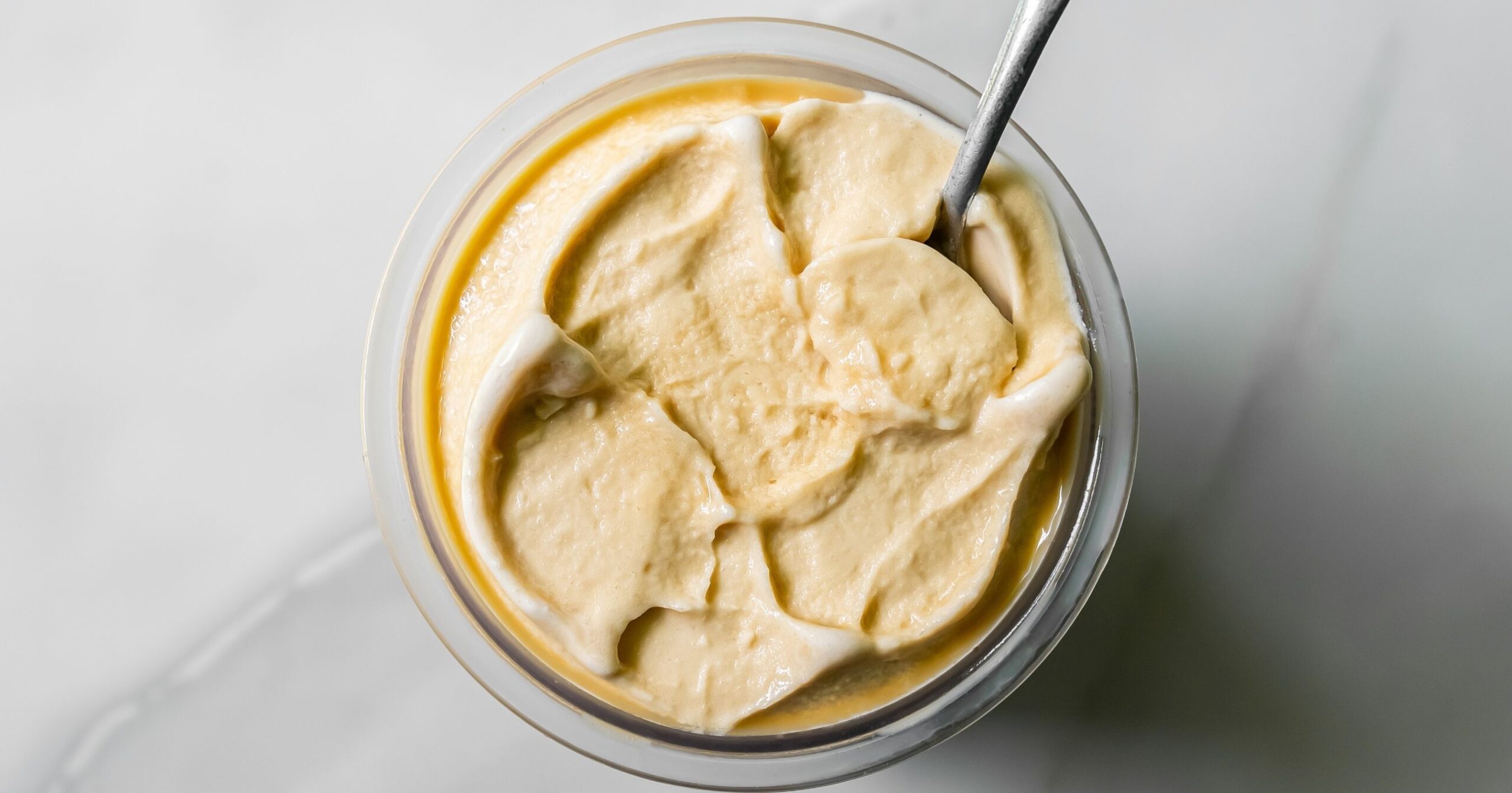 top view of oat milk protein coffee ice cream with a spoon
