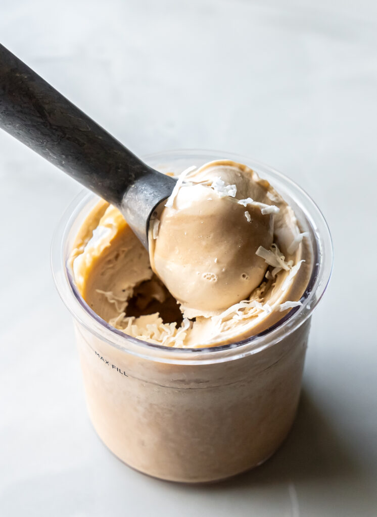 A scoop of Ninja Creami Pina Colada Protein Ice Cream in a cup, ready to enjoy.