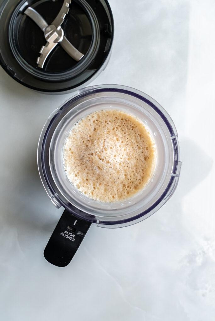 Transfered Frozen Pina Colada Protein Ice Cream mixture in a pint for spinning.