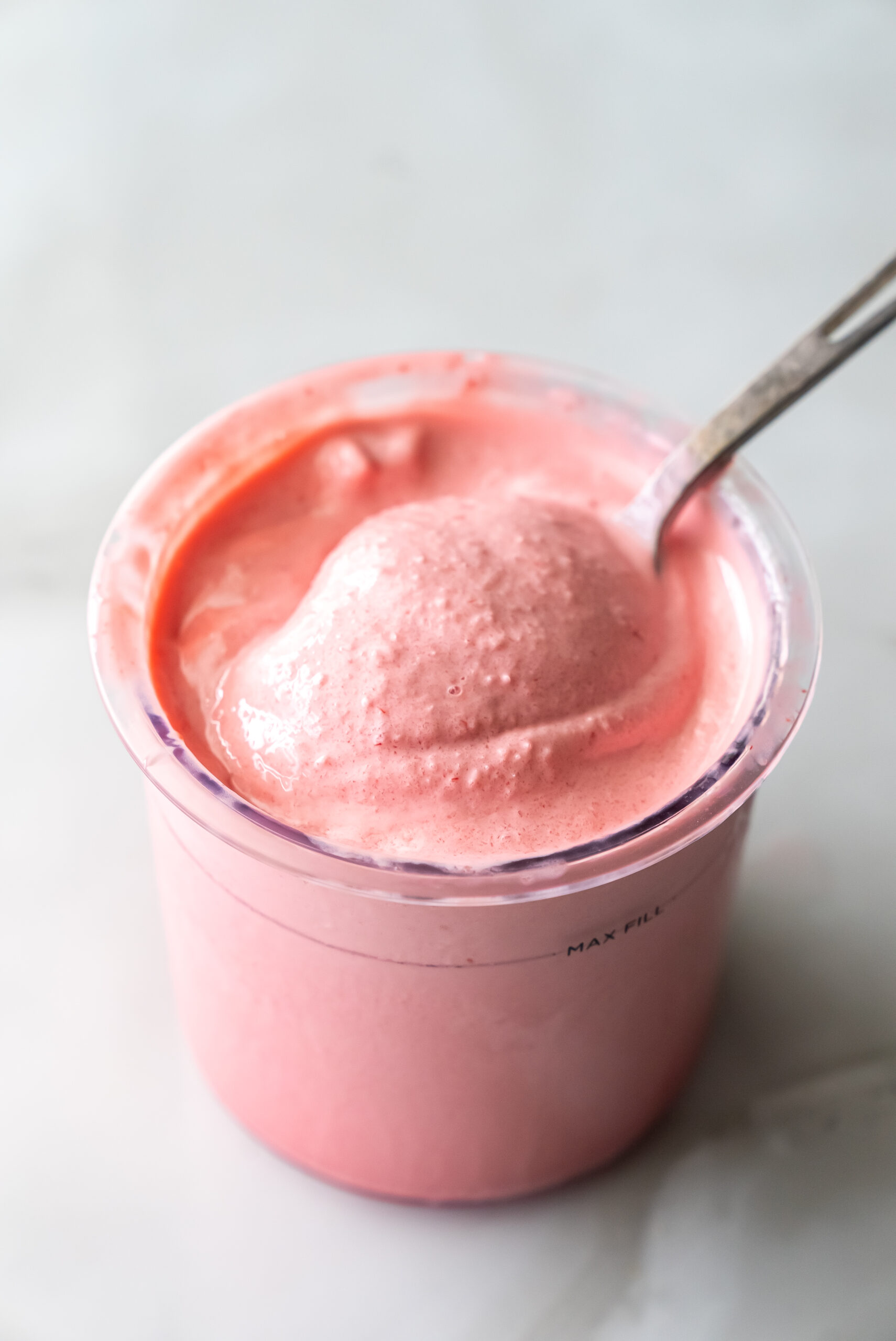 cherry protein ice cream with a spoon.