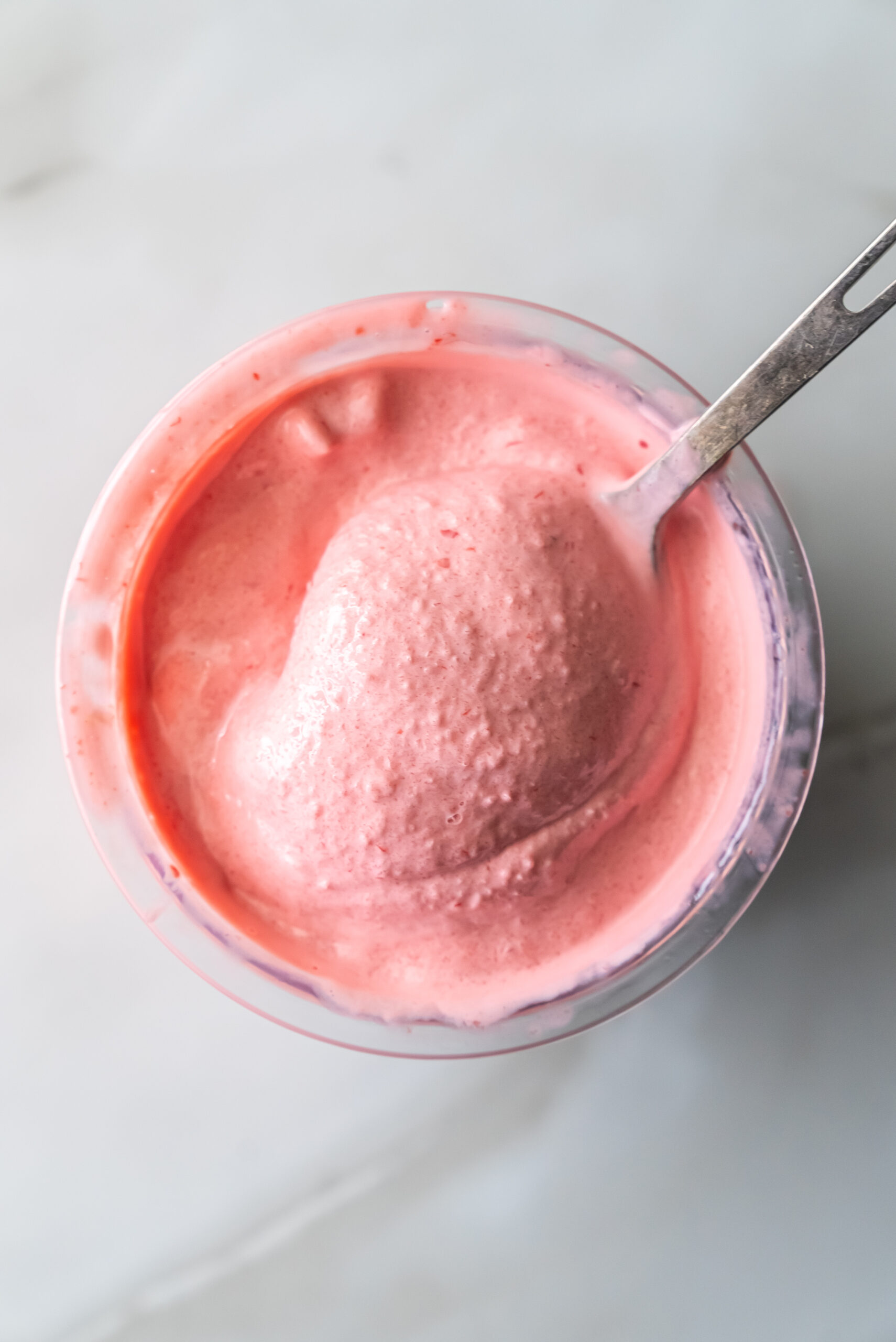 cherry protein ice cream with a spoon.