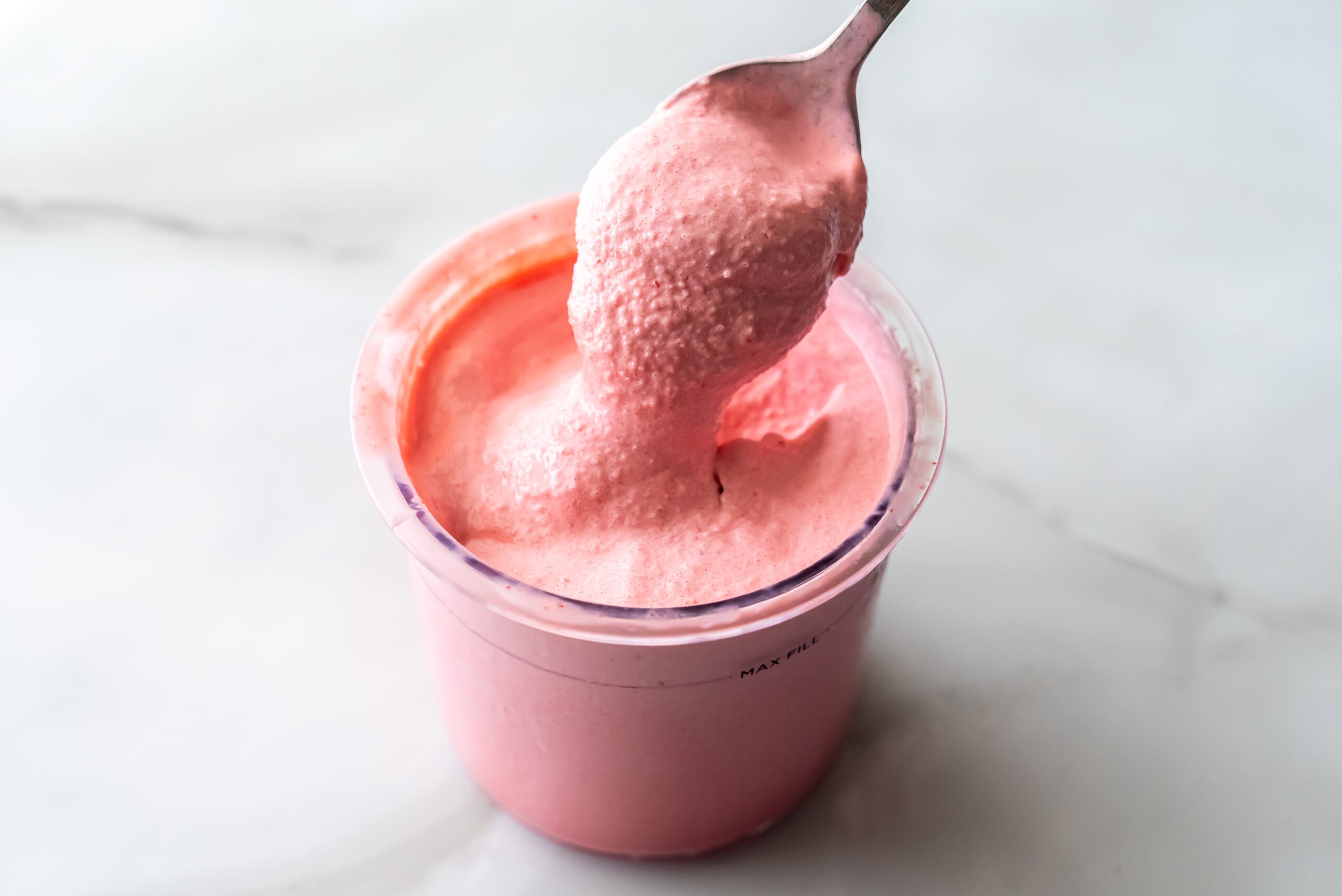 cherry protein ice cream with a spoon.
