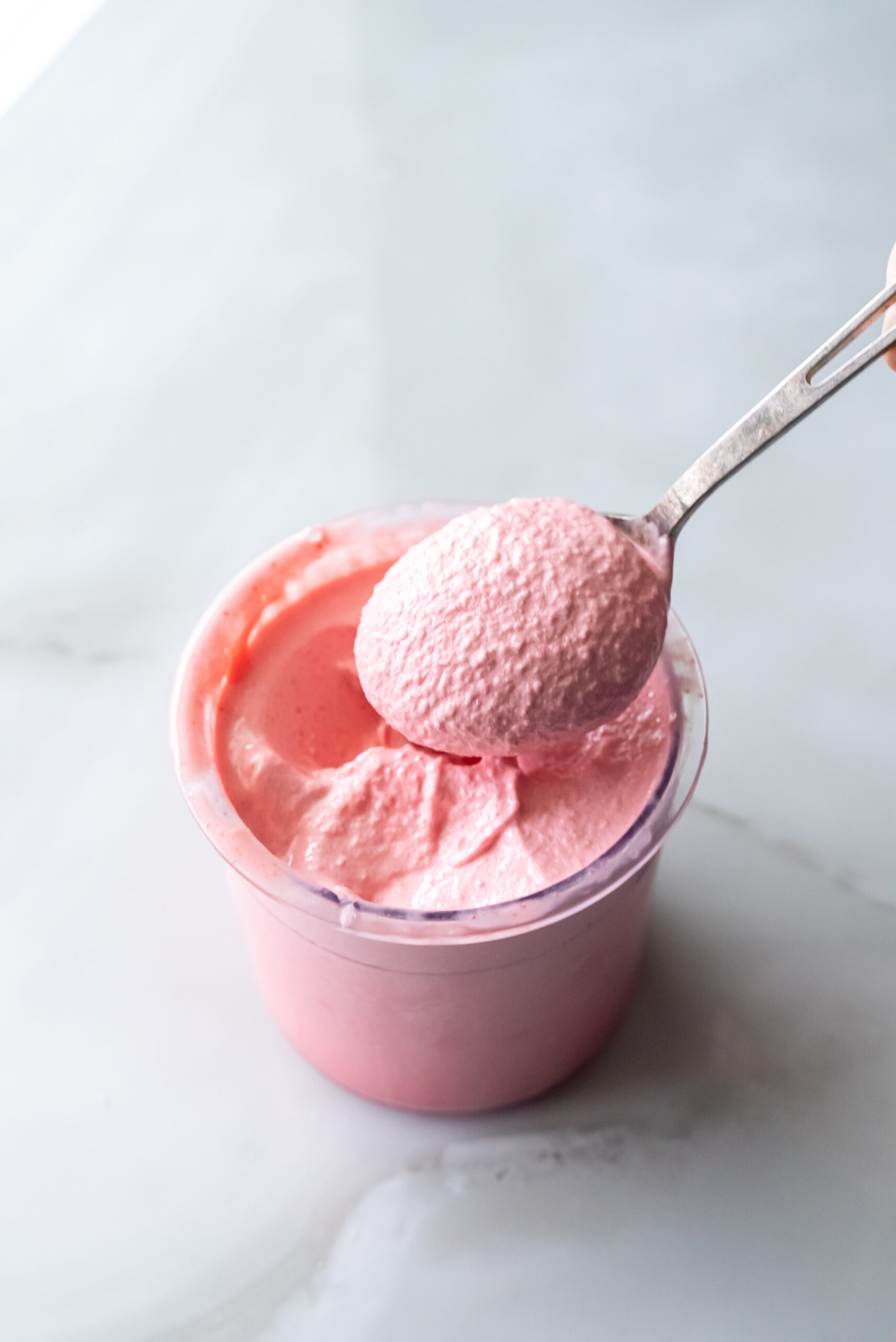 cherry protein ice cream with a spoon.